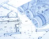 Zrolowane rysunki techniczne z planami architektonicznymi i wymiarami.