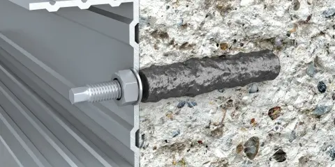 Przekrój profilu aluminiowego z widocznym elementem mocującym, który wchodzi w beton. To jest właśnie ankier – co to jest, widać na obrazku.
