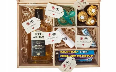 Drewniana skrzynka z zawartością: butelka whisky, smoczek, czekoladki, leki, pieniądze i losy. To idealny **niezbędnik małżeński co włożyć** na szczęście i przyszłość.