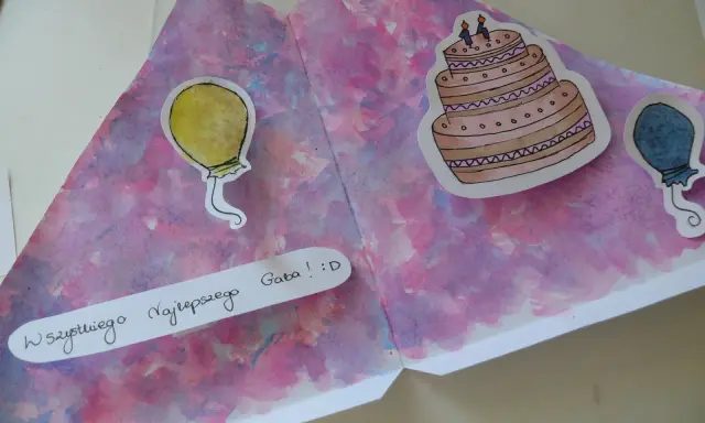 Kolorowa kartka urodzinowa DIY z namalowanym tortem i balonami. Napis "Wszystkiego Najlepszego Gaba! :D" dodaje osobistego charakteru.